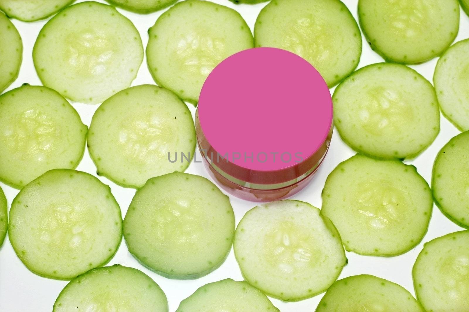 Moisturizing cucumber day cream  surrounded with cucumber slices
