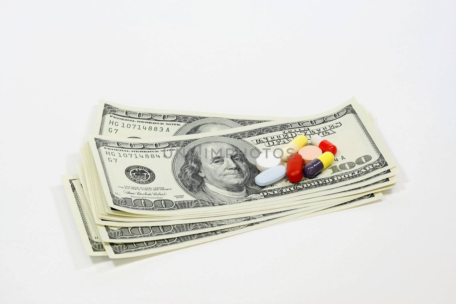 Tablets and pills on dollar banknotes Conceptual photo