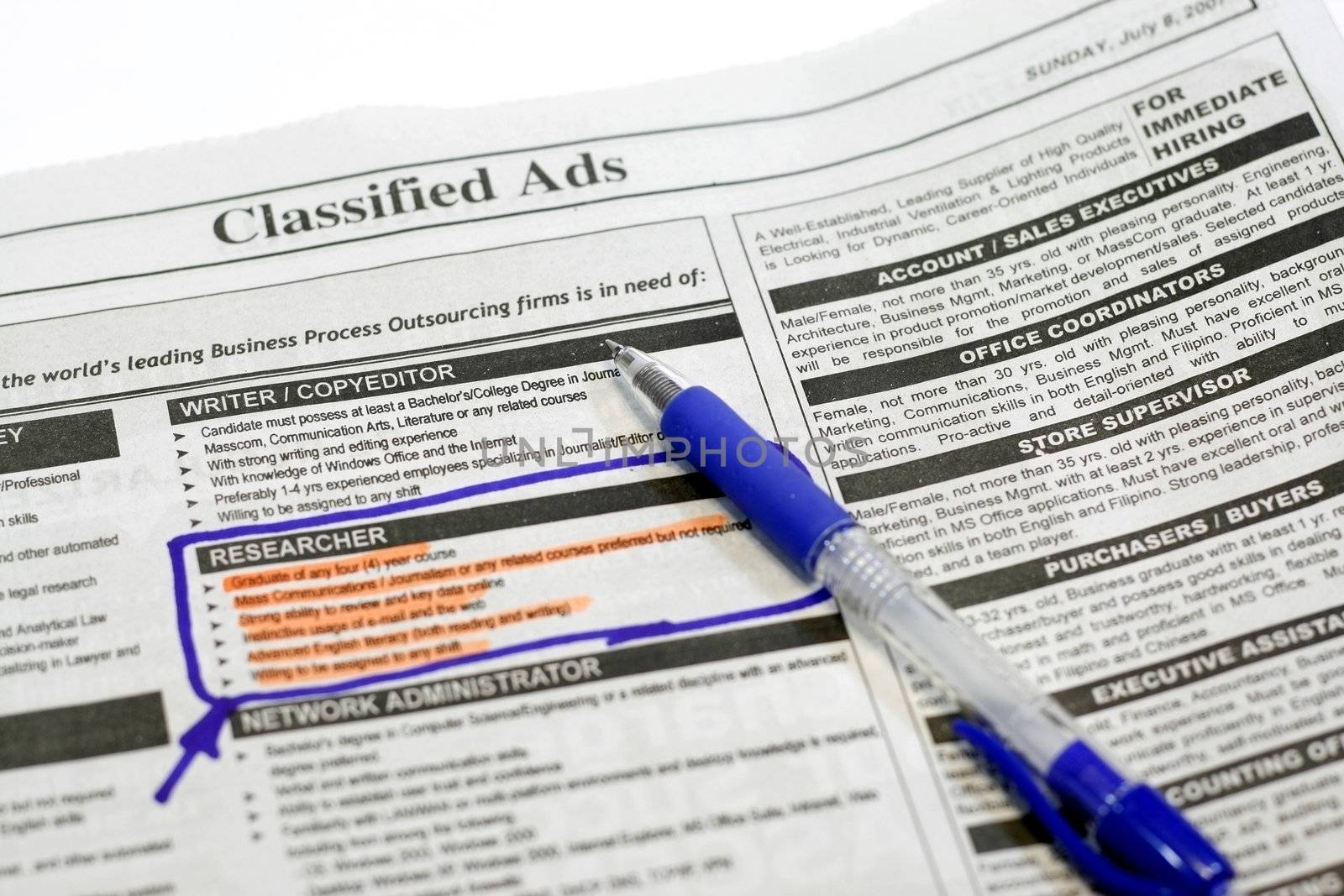 newspaper opened to the want ads  highlighting the applied position

