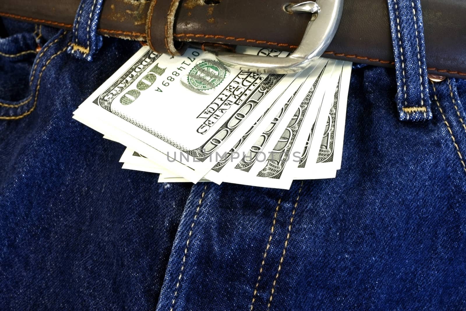 denim jeans with leather belt and dollar bill
