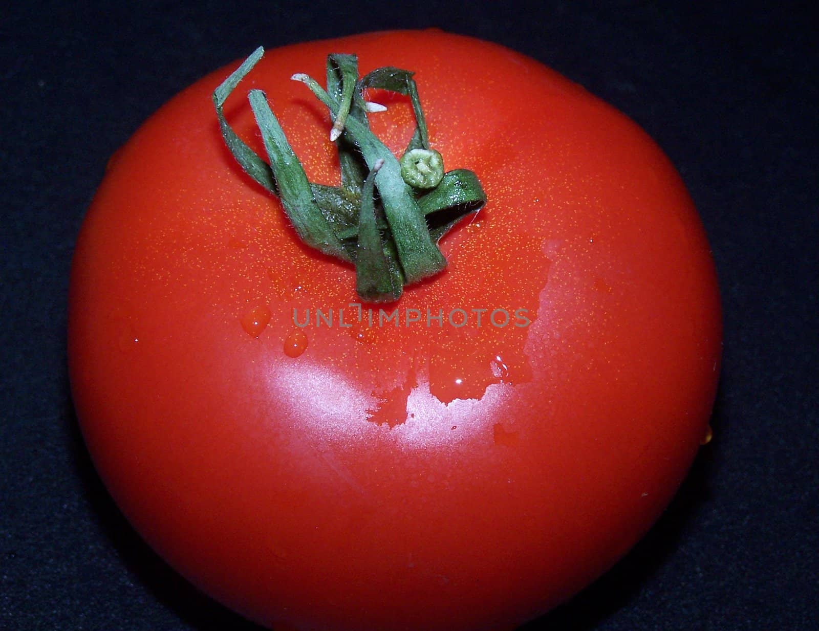 Tomato with droplets of water.