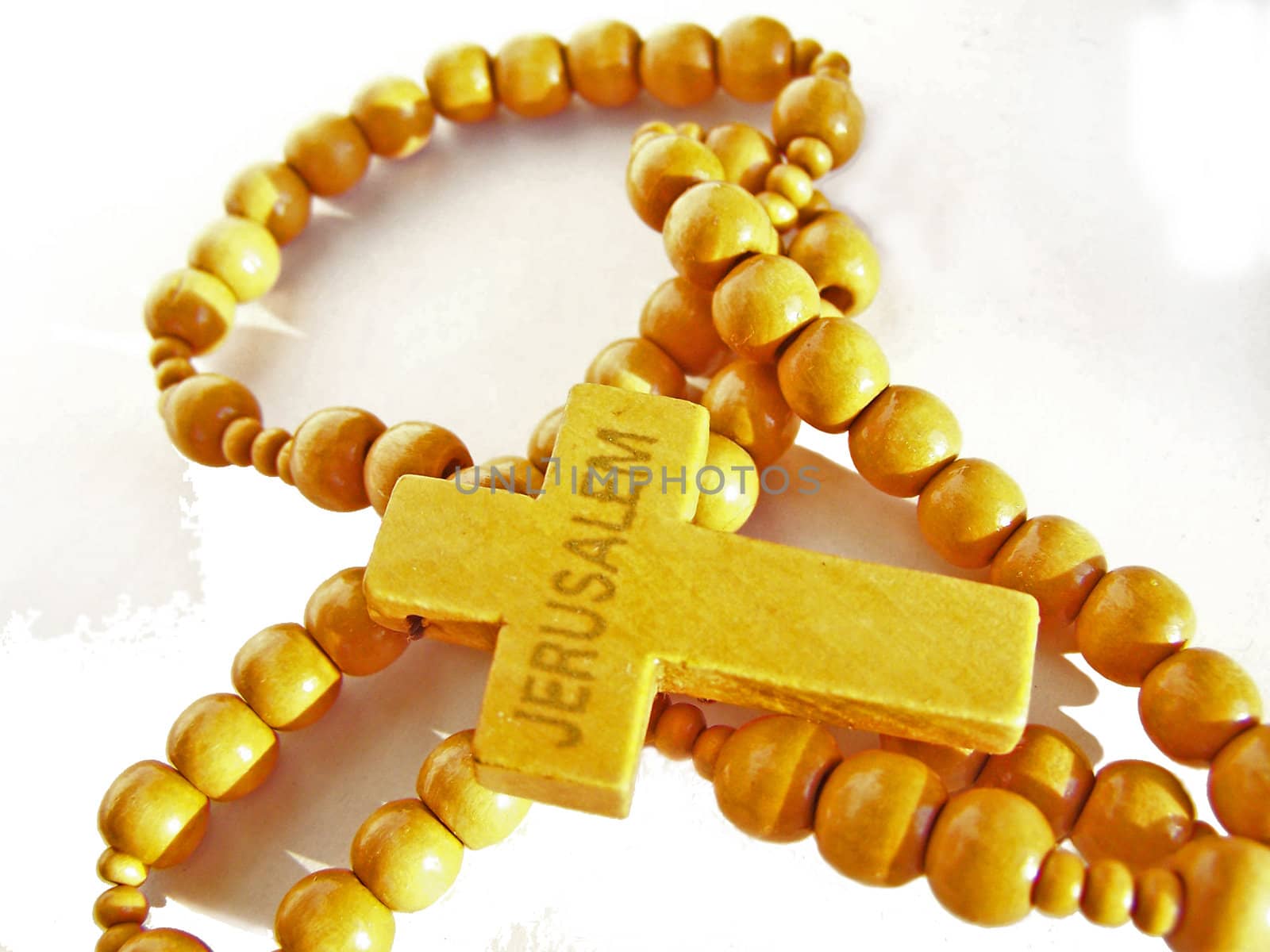 Wooden cross with beads. Close up. Isolated. 