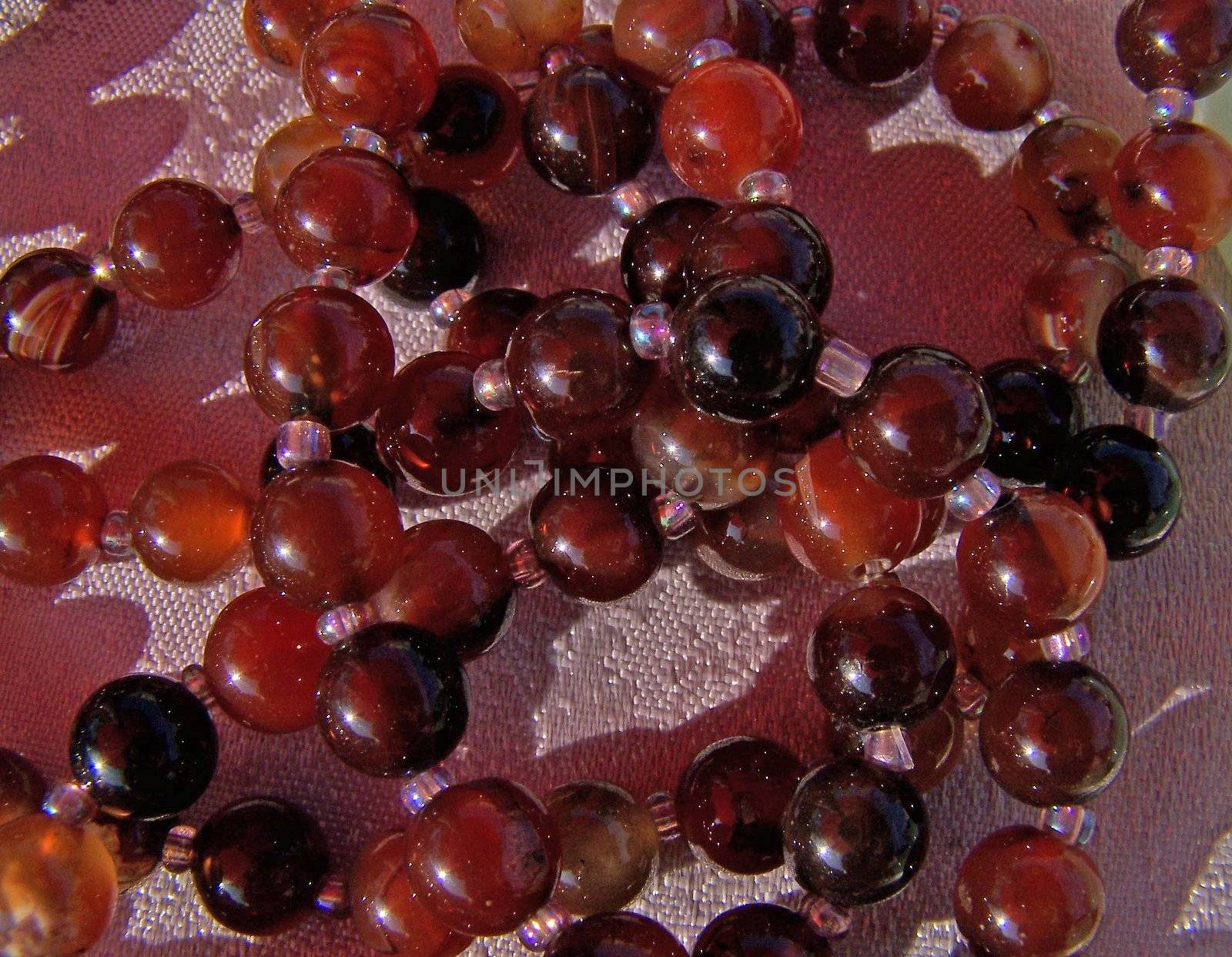Cornelian beads snined by sun. Close up.