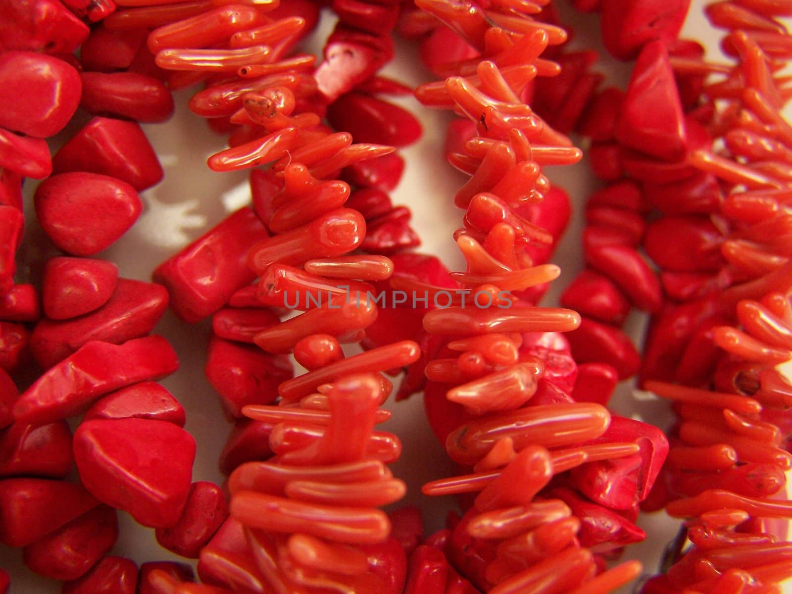 Different red coral beads. Close up. Background