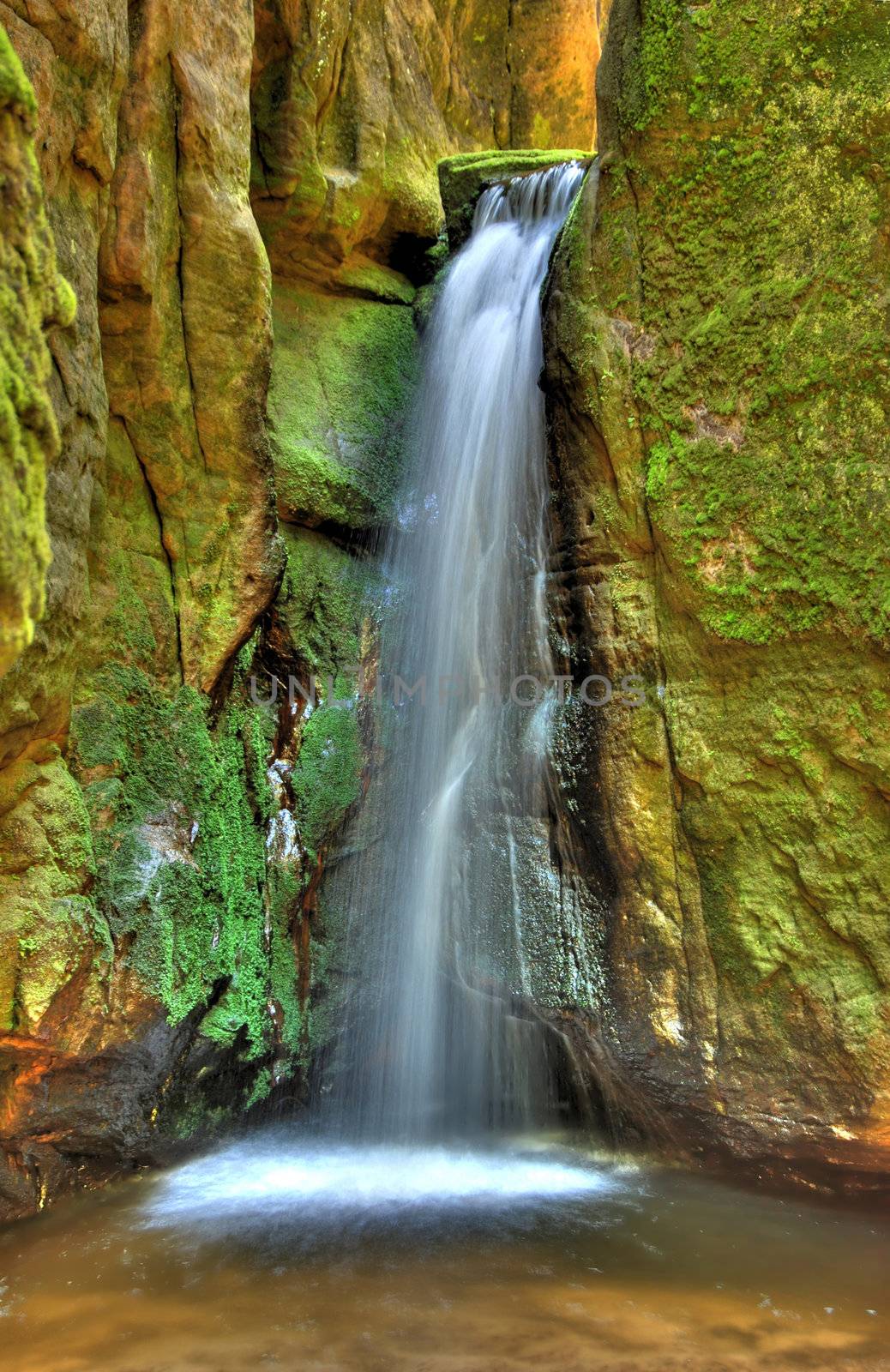 Waterfall in Aderspach sandstone rock city in Czech Republic