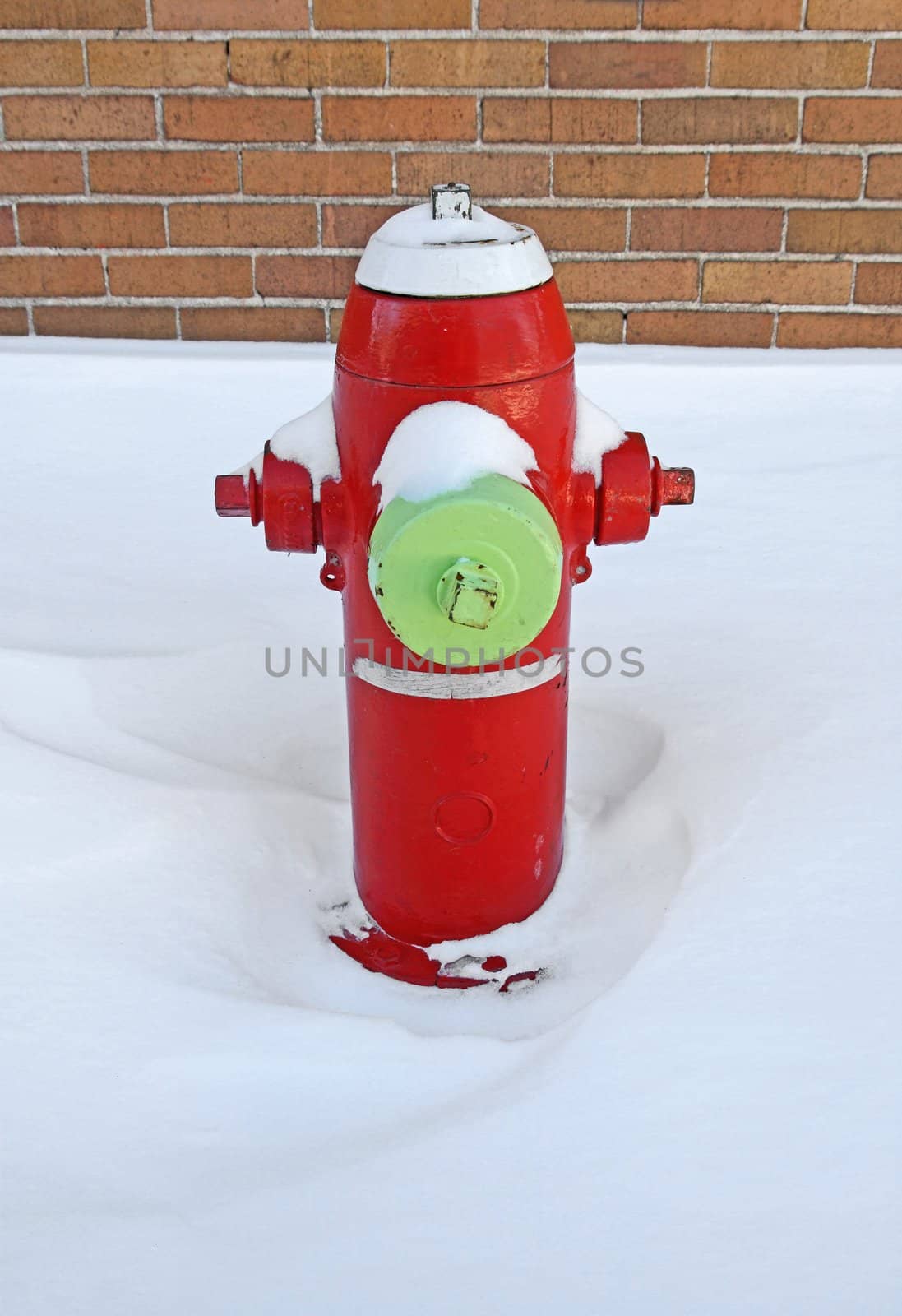 Red fire hydrant covered by snow by anikasalsera
