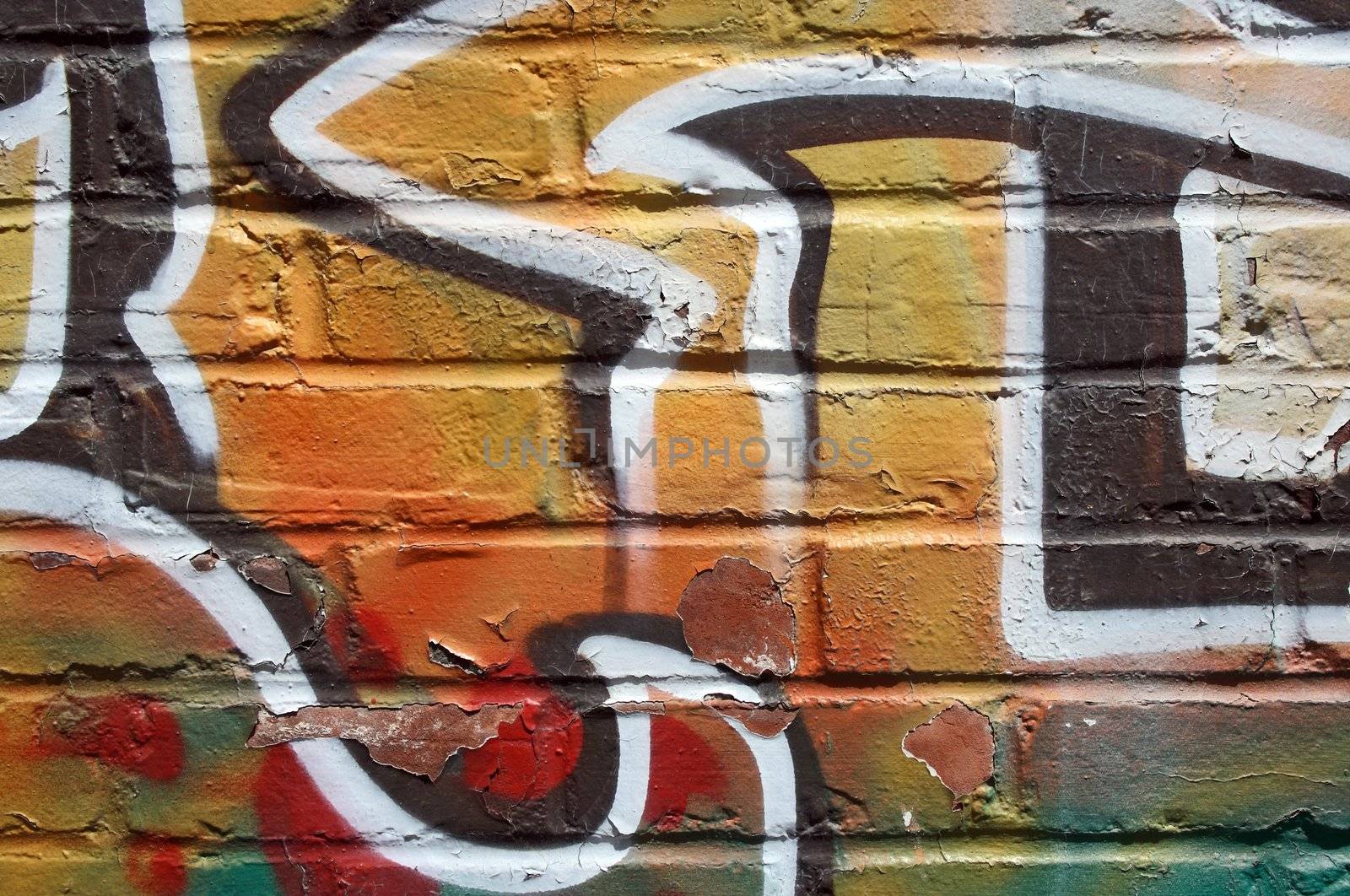 Bright colorful graffiti on a peeling brick wall.