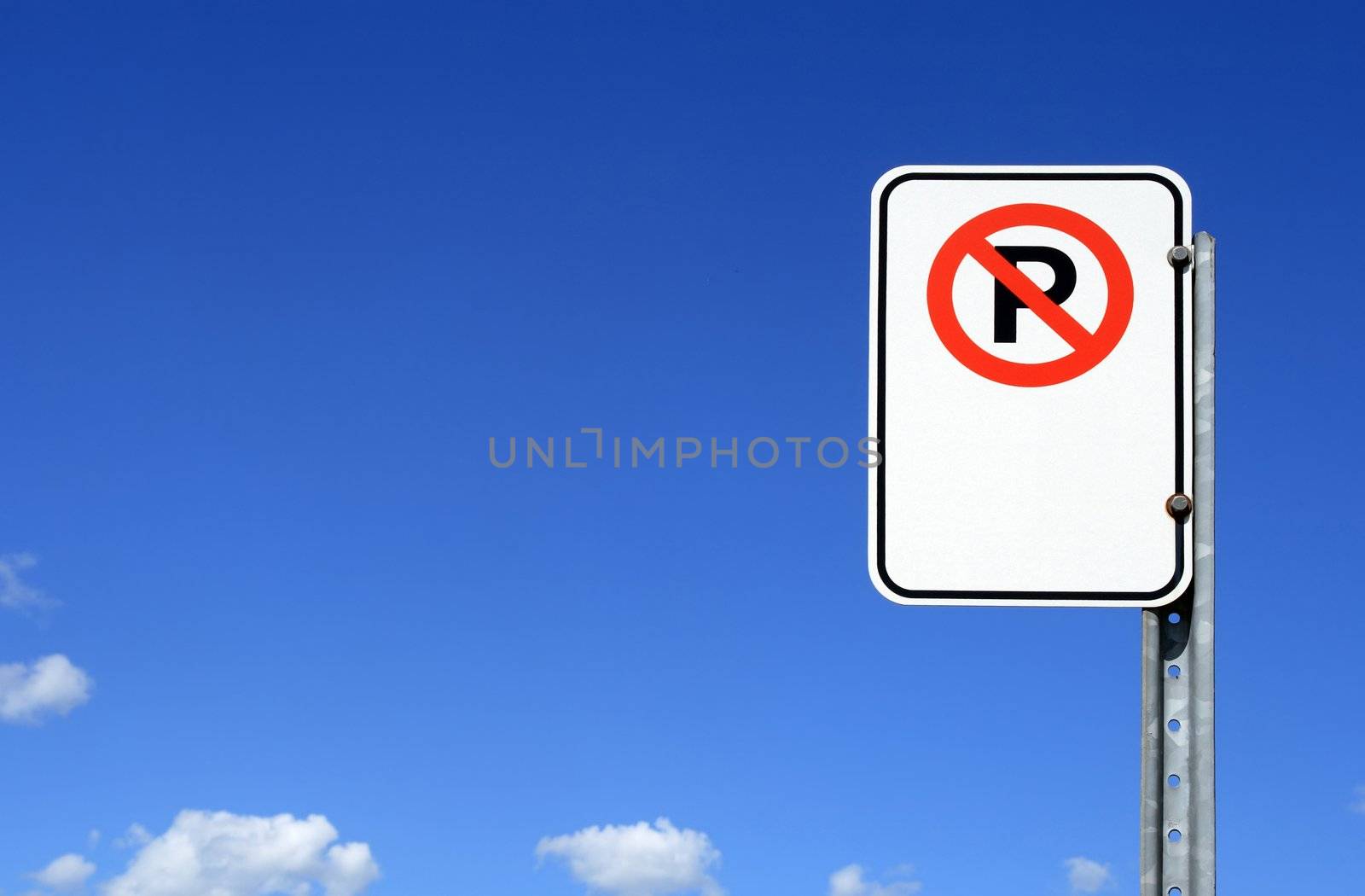 No parking sign with copy space against the blue sky.