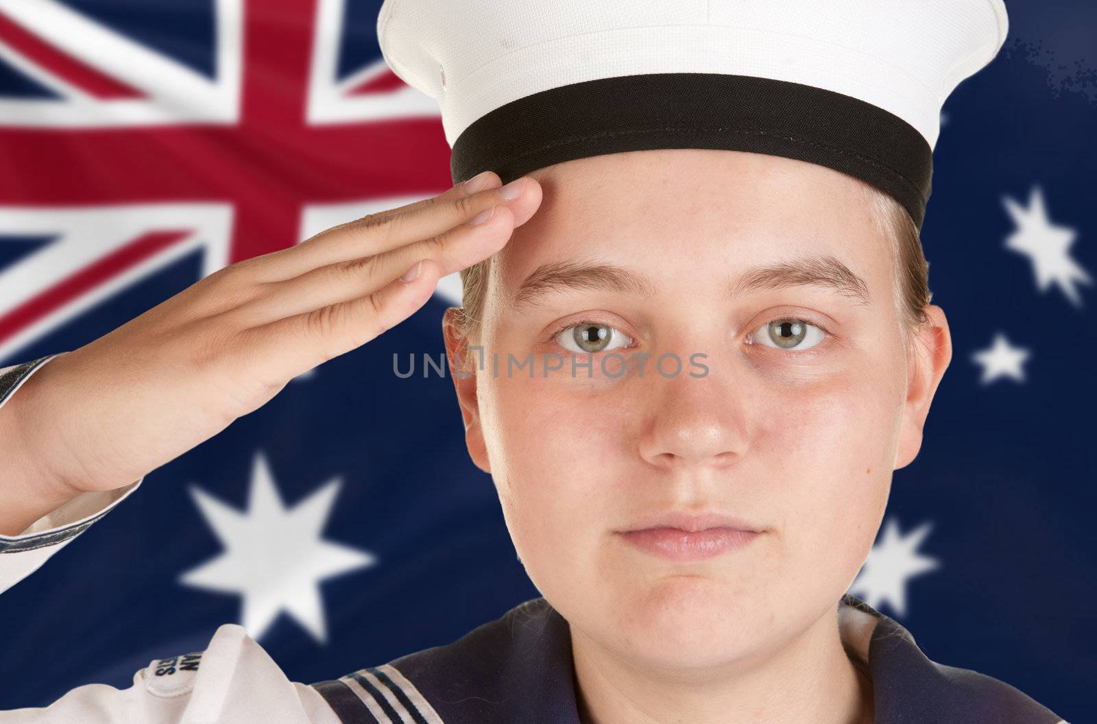 young female sailor saluting in front of australian flag