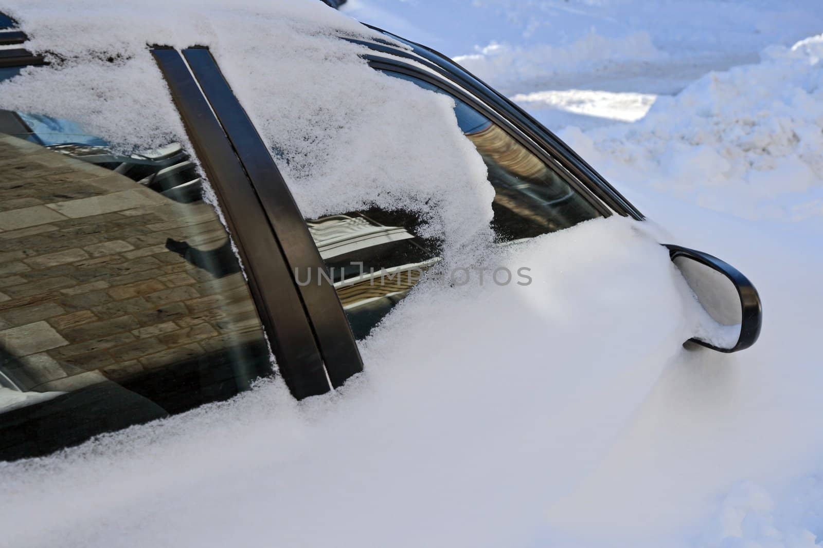 Car stuck in the snowdrift after the heavy snowstorm.
