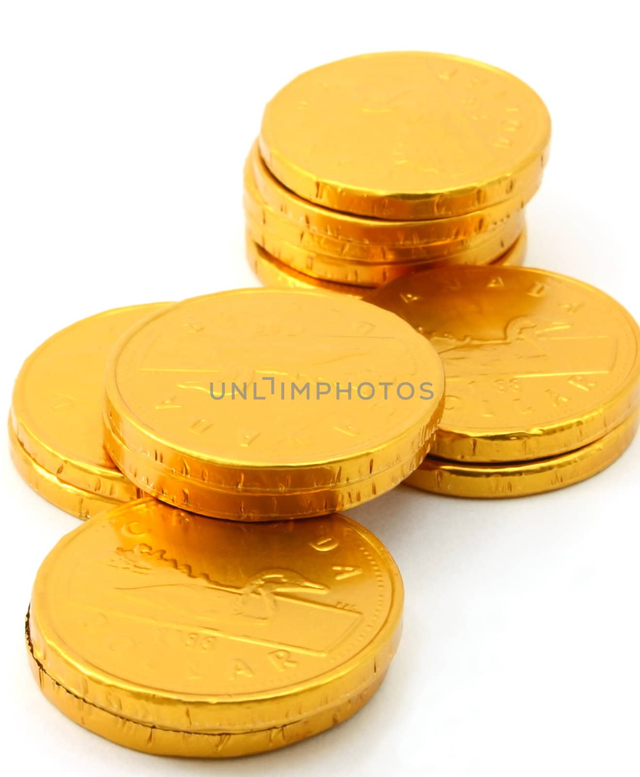 Chocolate gold coin stacks, isolated, portrait view