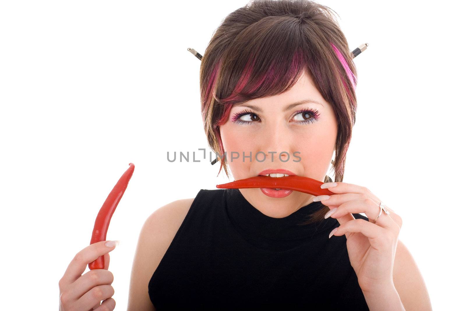 Sexy hot woman biting red chilli peppers