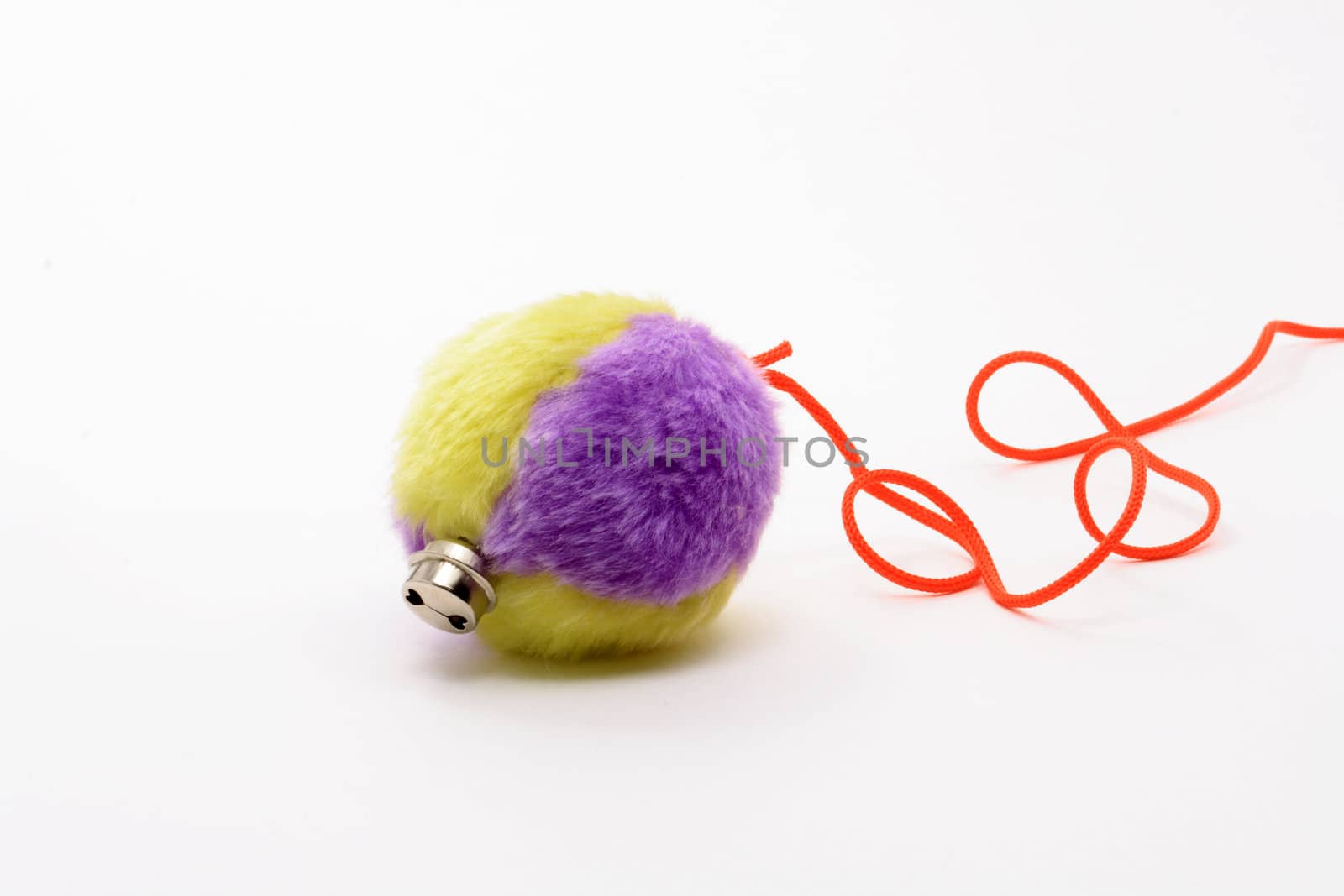 Colored soft ball with red rope on white background