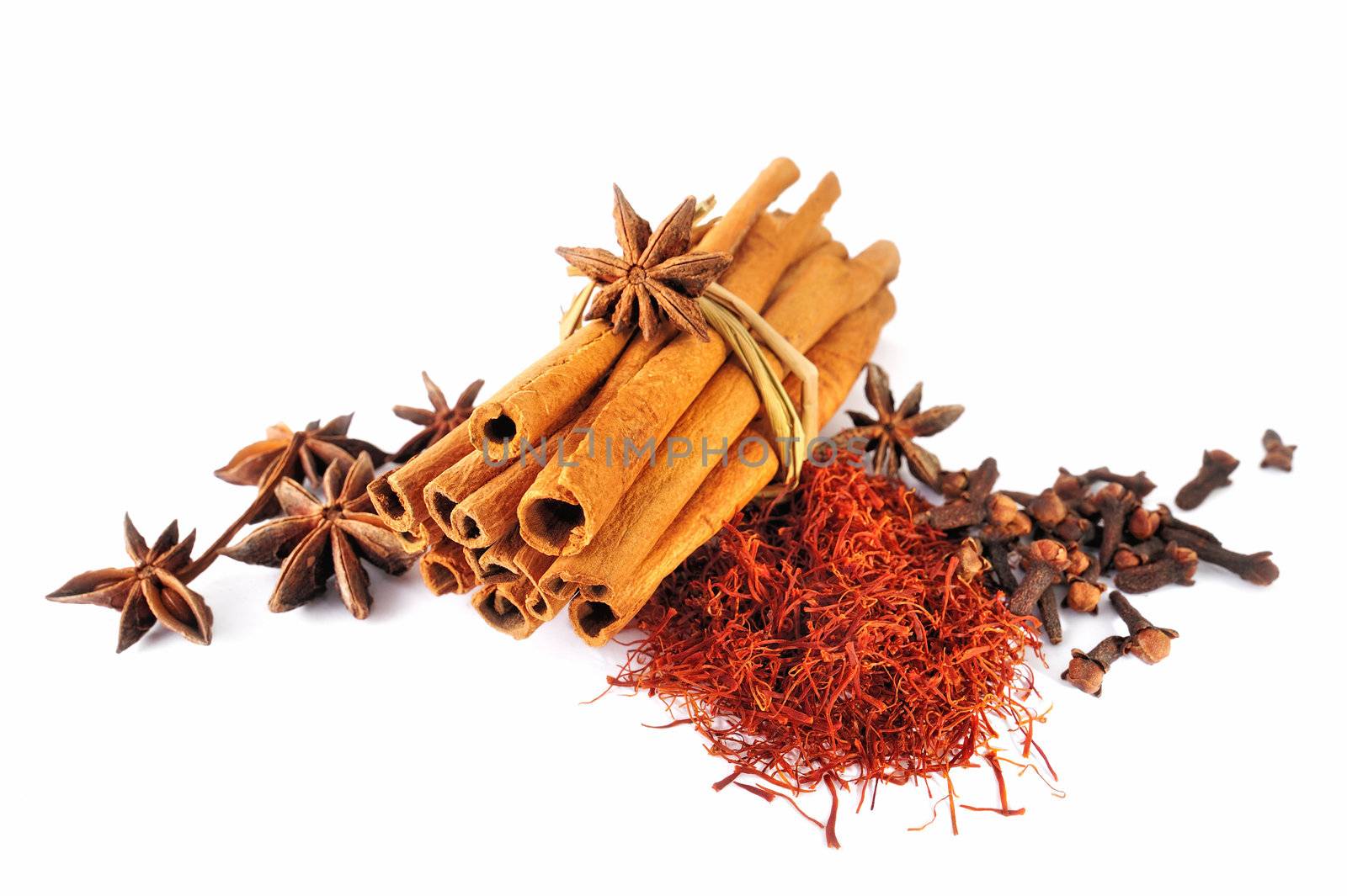 Dry cinnamon sticks and spice on white background