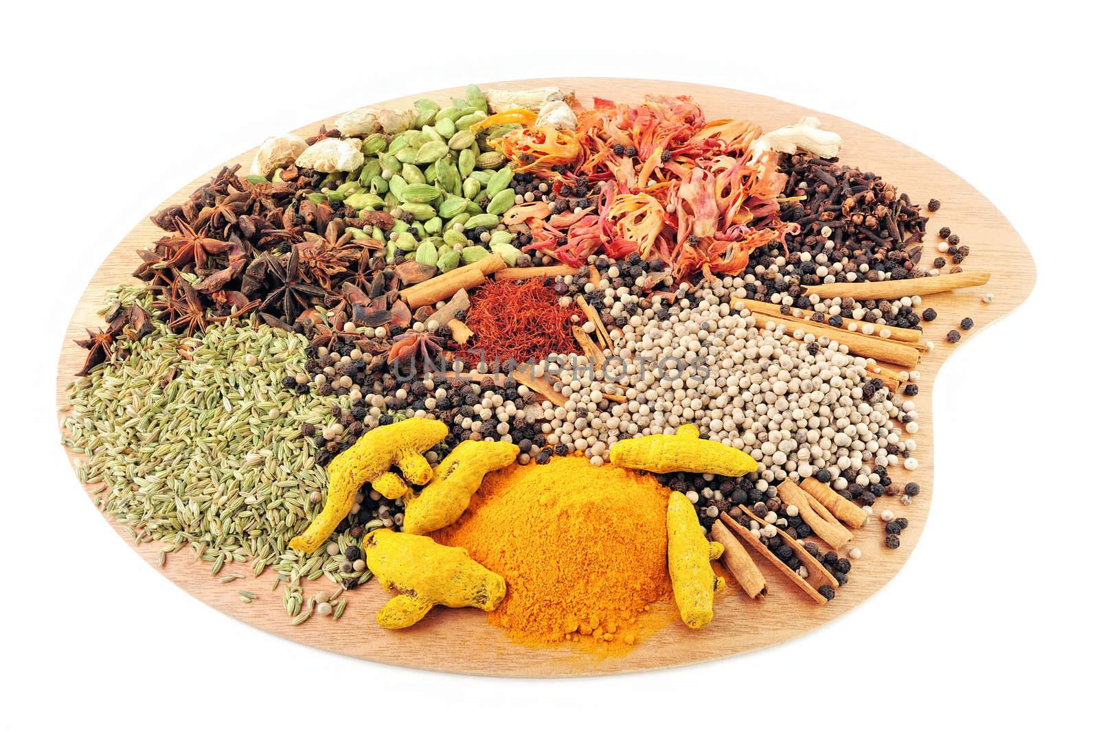 Various Spices are located on a wooden palette
