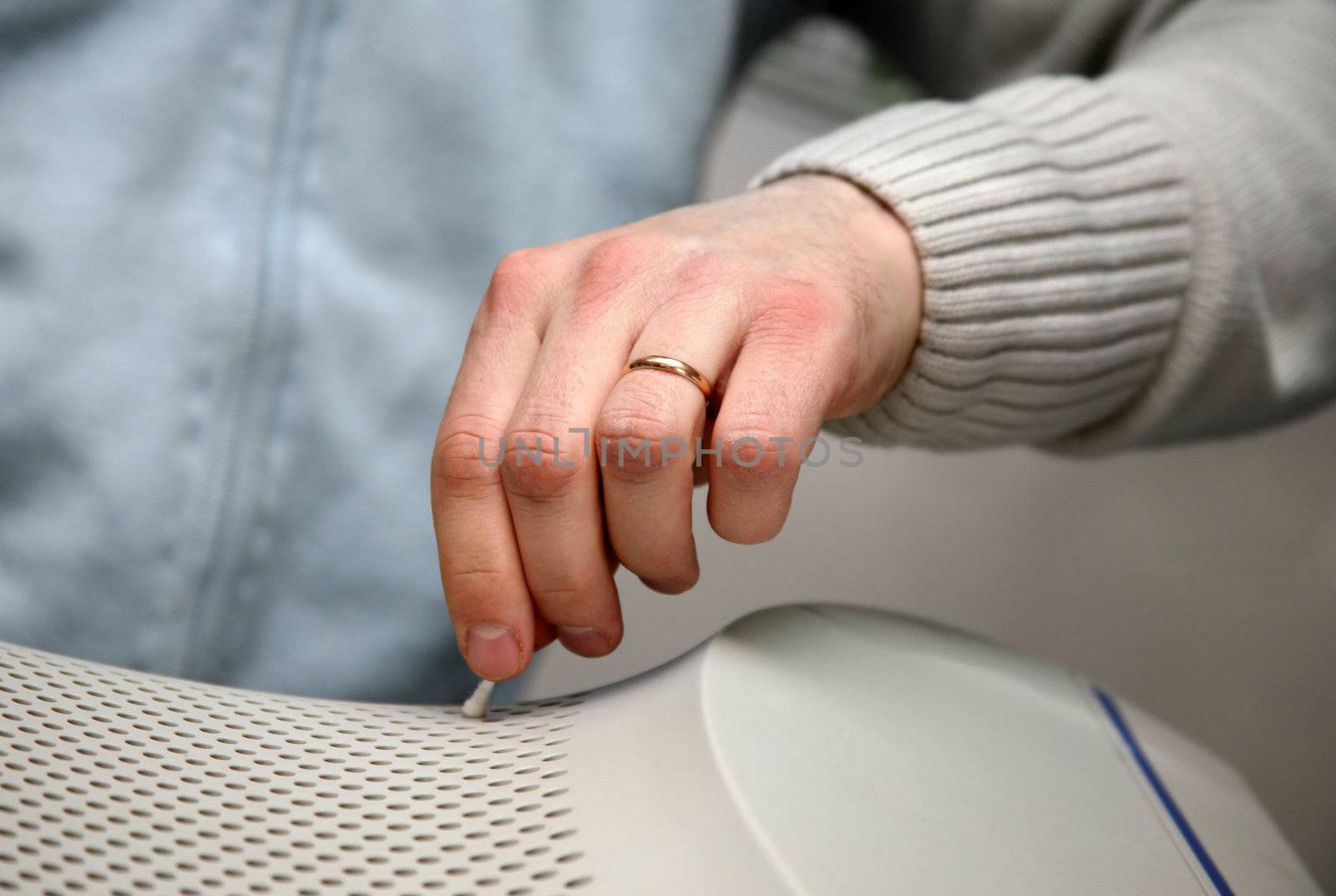 The man cleans a surface of the monitor