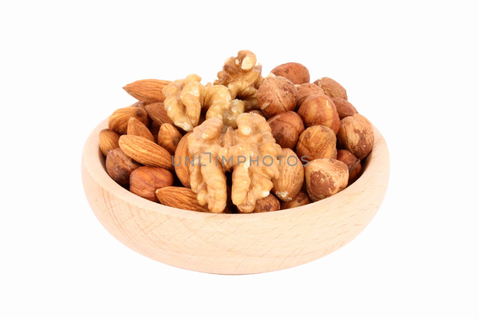 Wood bowl full of walnuts, almonds and hazelnuts, isolated
