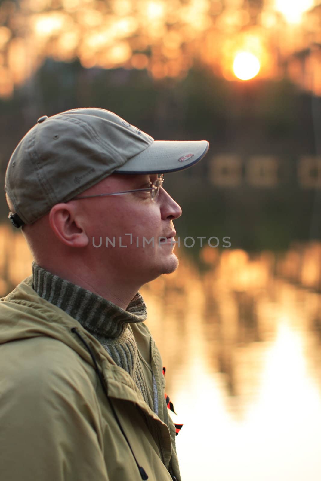 Portrait of the young man on a bacground of sunset