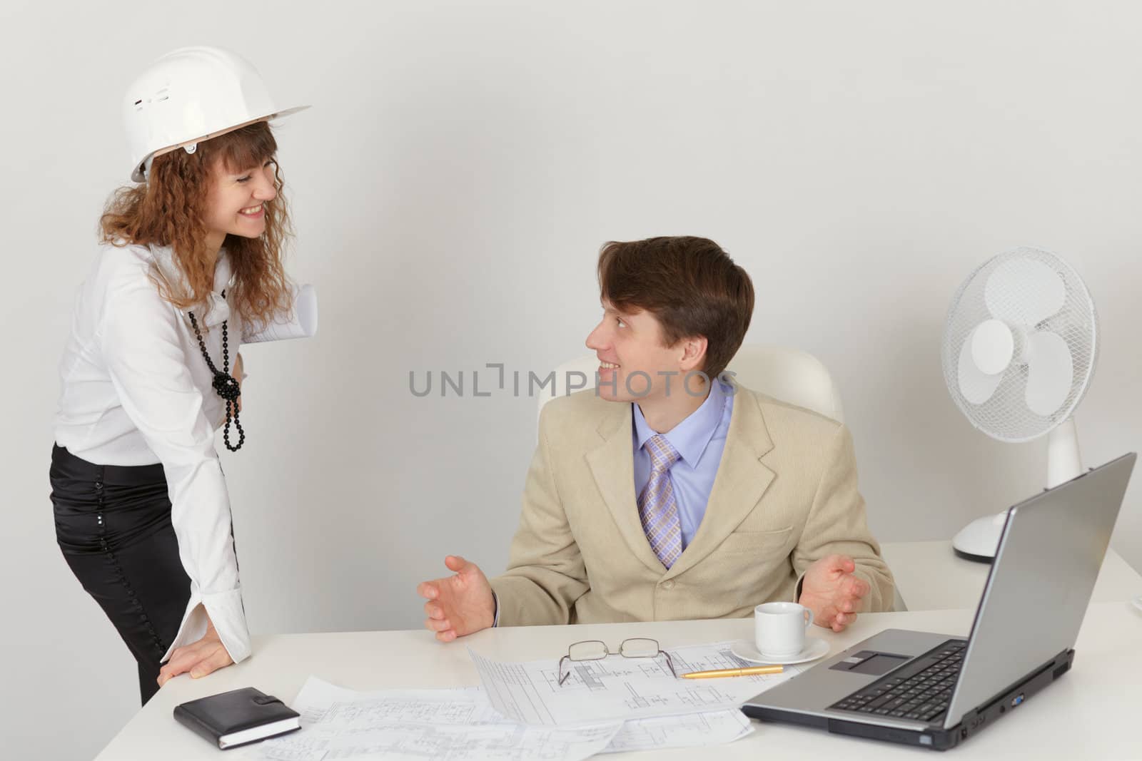 Two engineers talking in the office during work