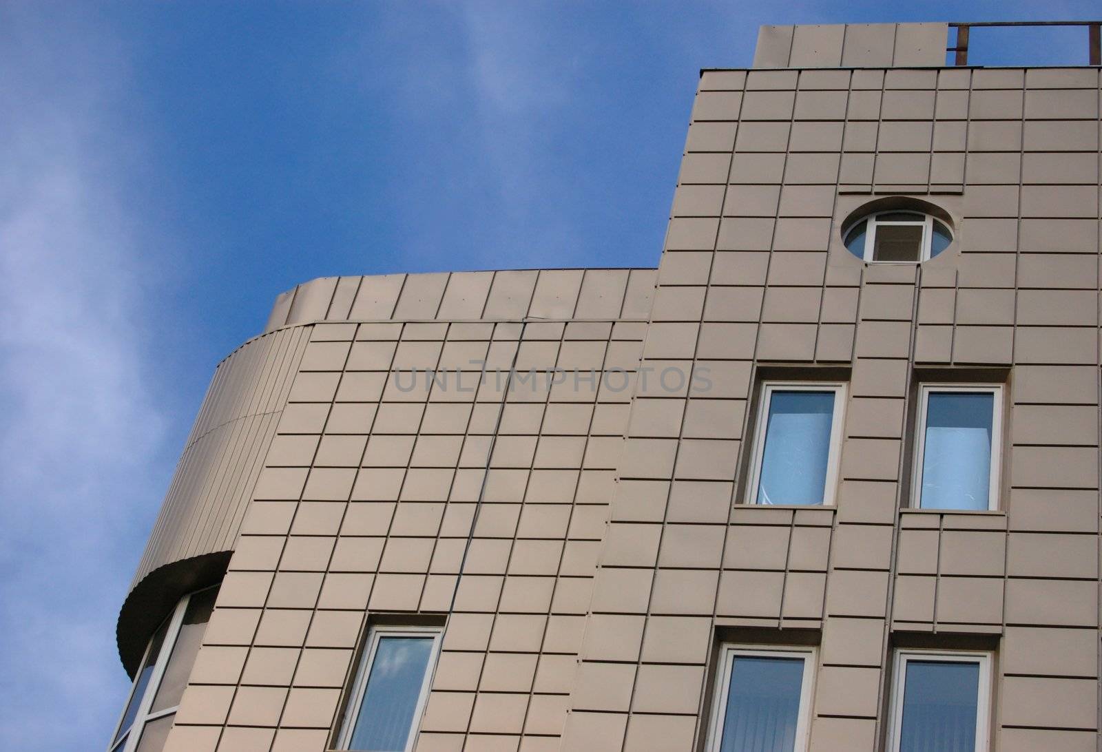 modern office building over blue sky with clouds