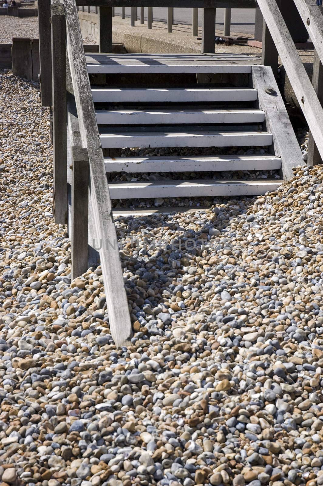 A pebble beach with wooden steps