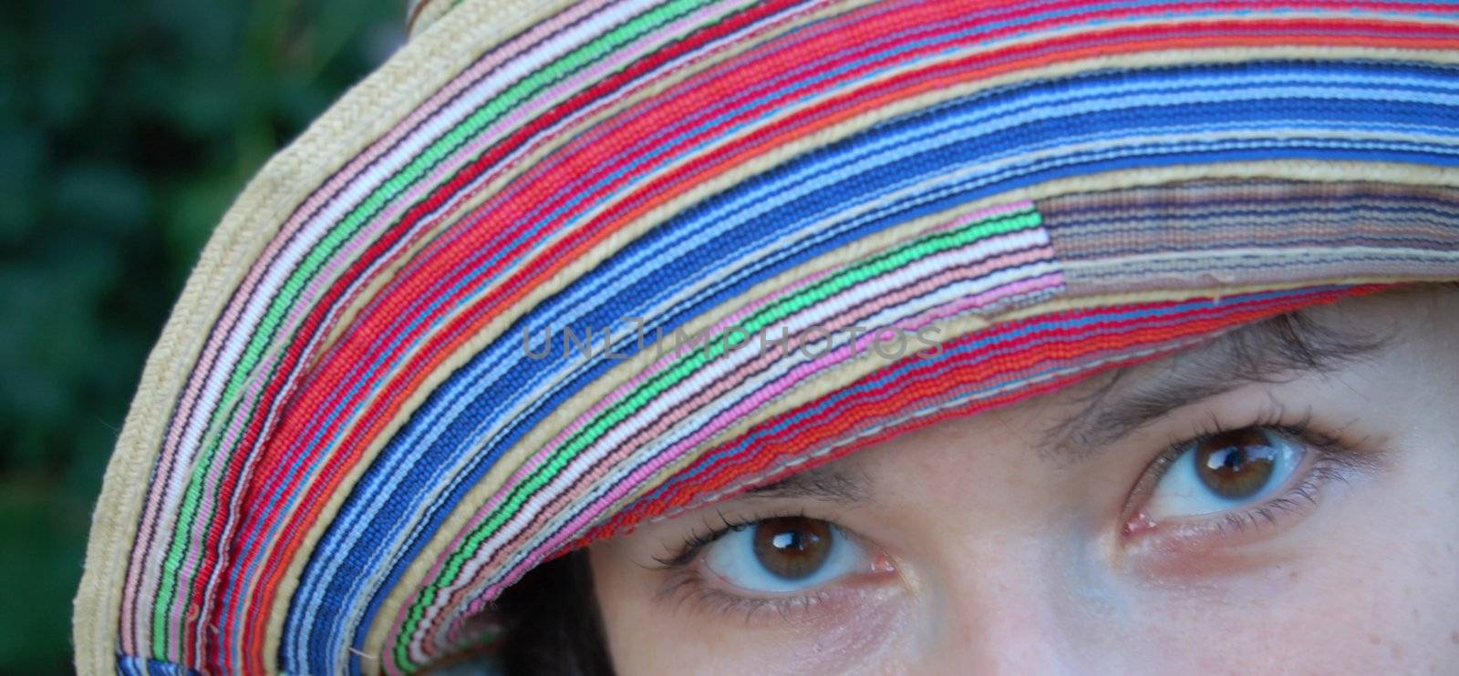 close-up of eyes of attractive young women in colorful hat