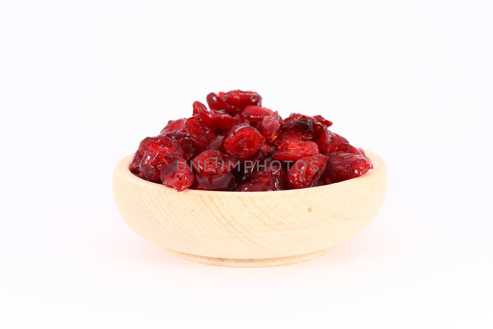 Dried cranberries in wooden bowl by Boris15