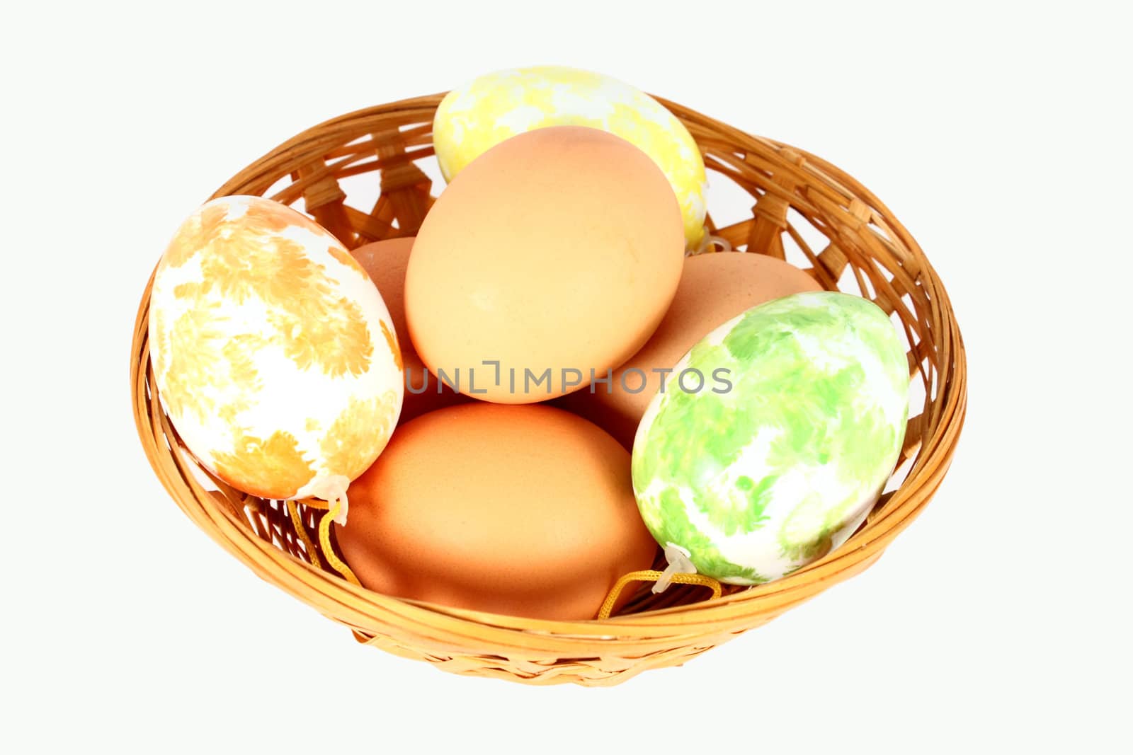 Basket containing easter eggs, isolated on white