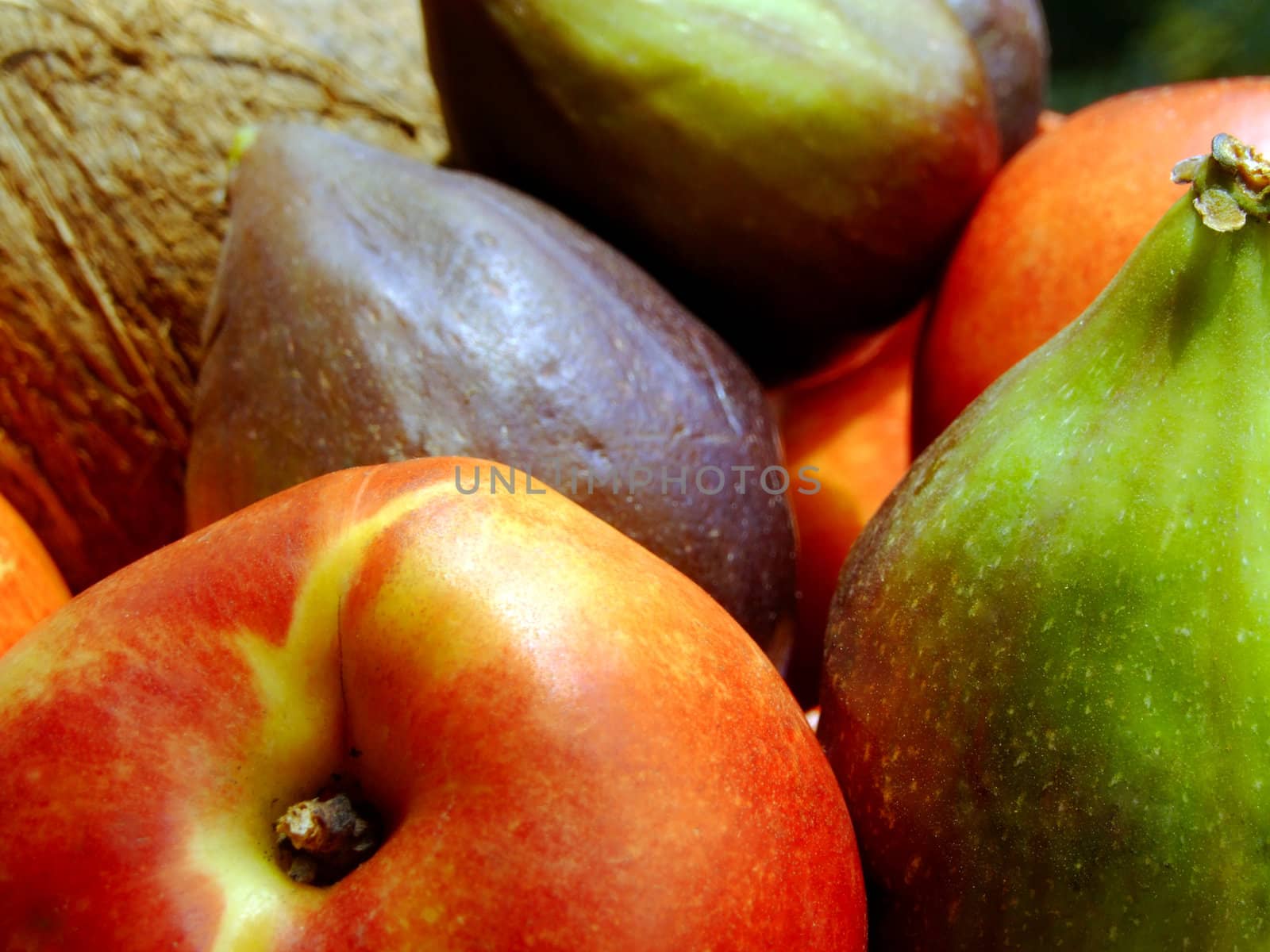 Close-up of fresh mixed fruit: coconut, peaches and figs