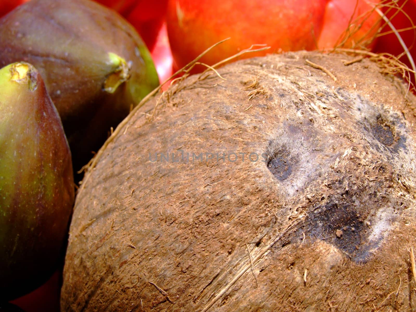 Close-up of fresh mixed fruit: coconut, peaches and figs