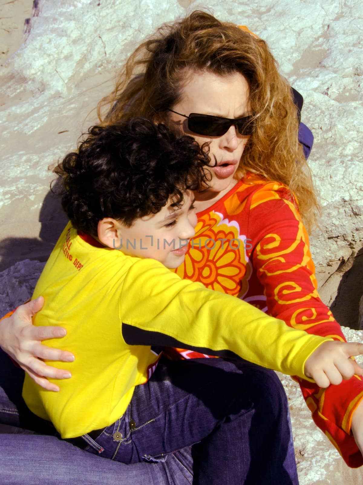 Mother and child on the rocks at the seaside