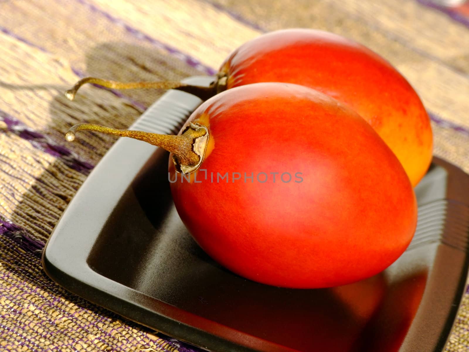 Close-up of two ripe tamarillos