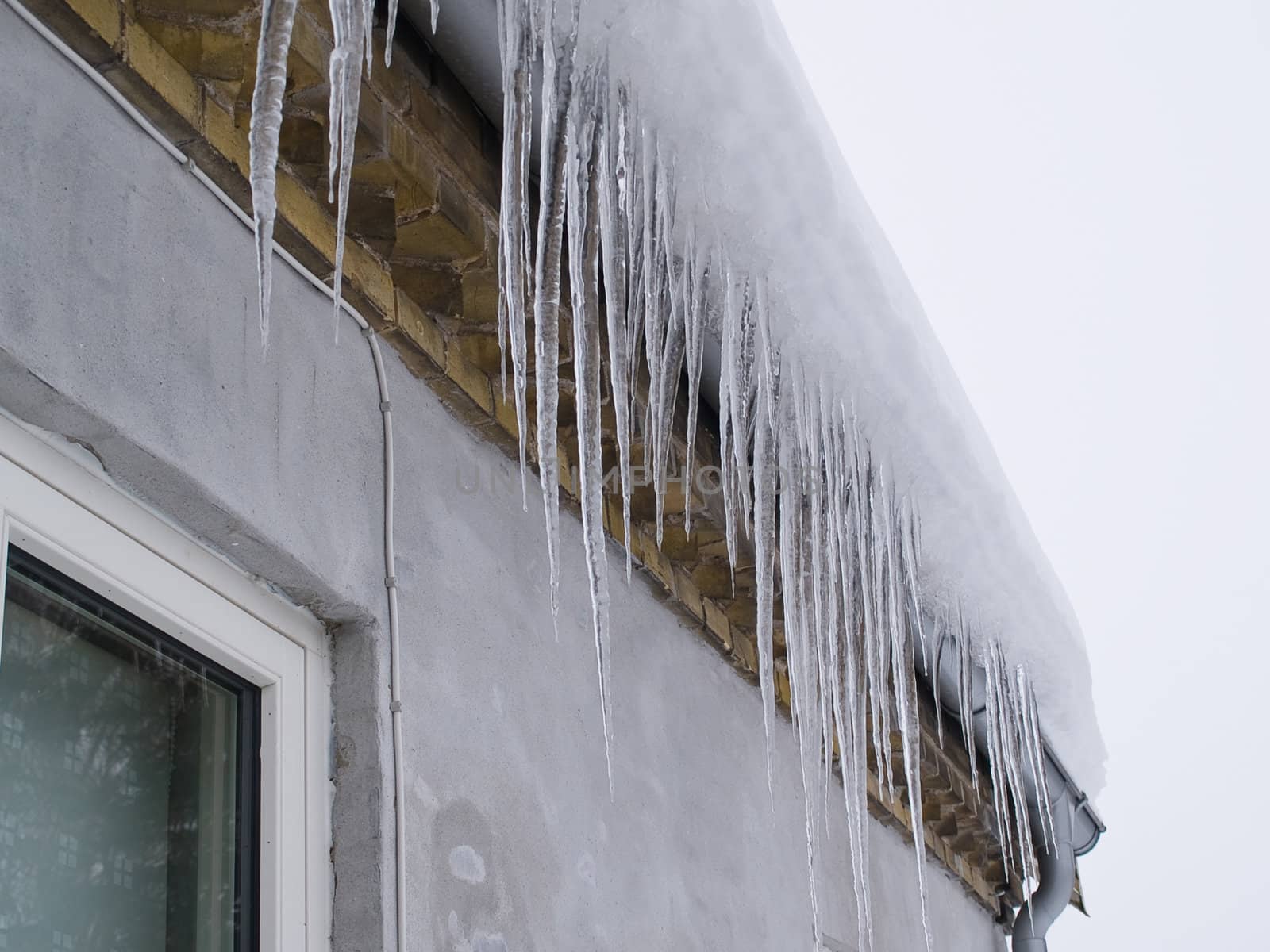 Icicles on a roof winter background image