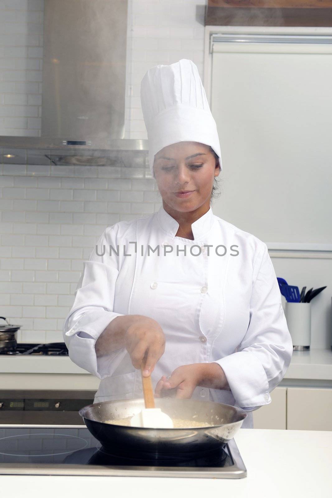 Chef cooking risotto stirring with ladle