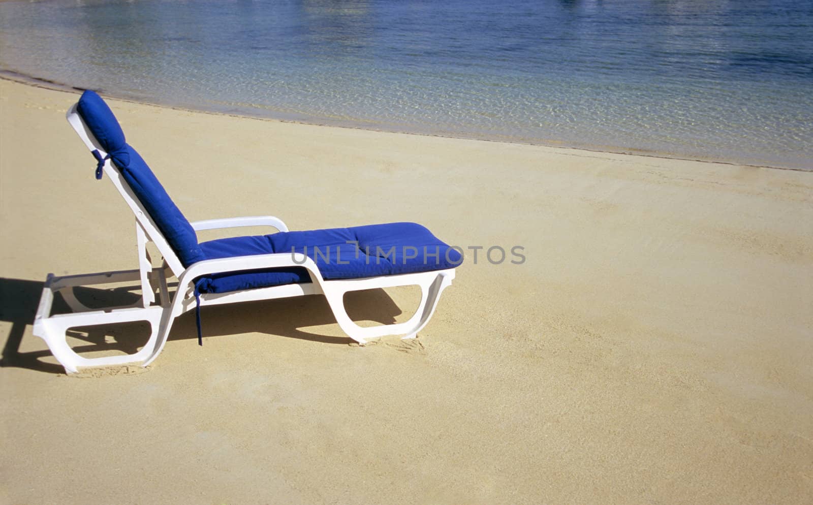 A deserted deck chair on the Romantic Great Exuma Island, The Bahamas.