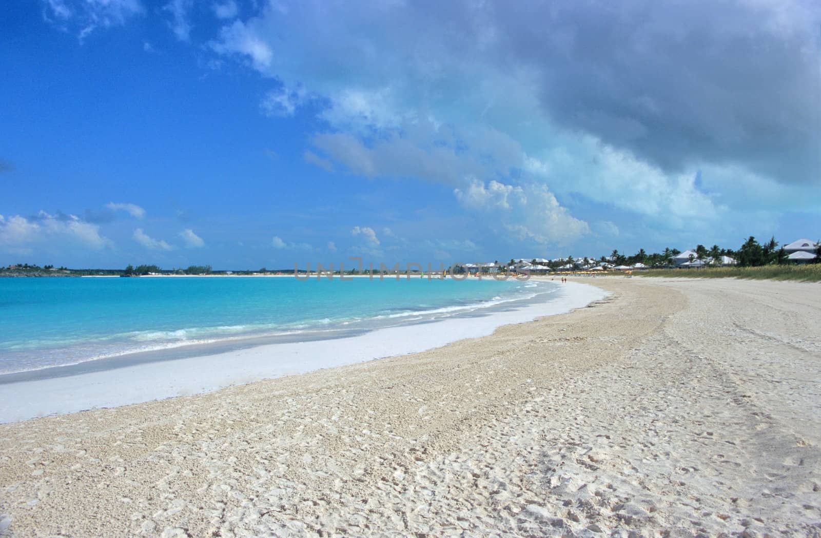 The pristine white sandy beach of a Bahamas resort area.