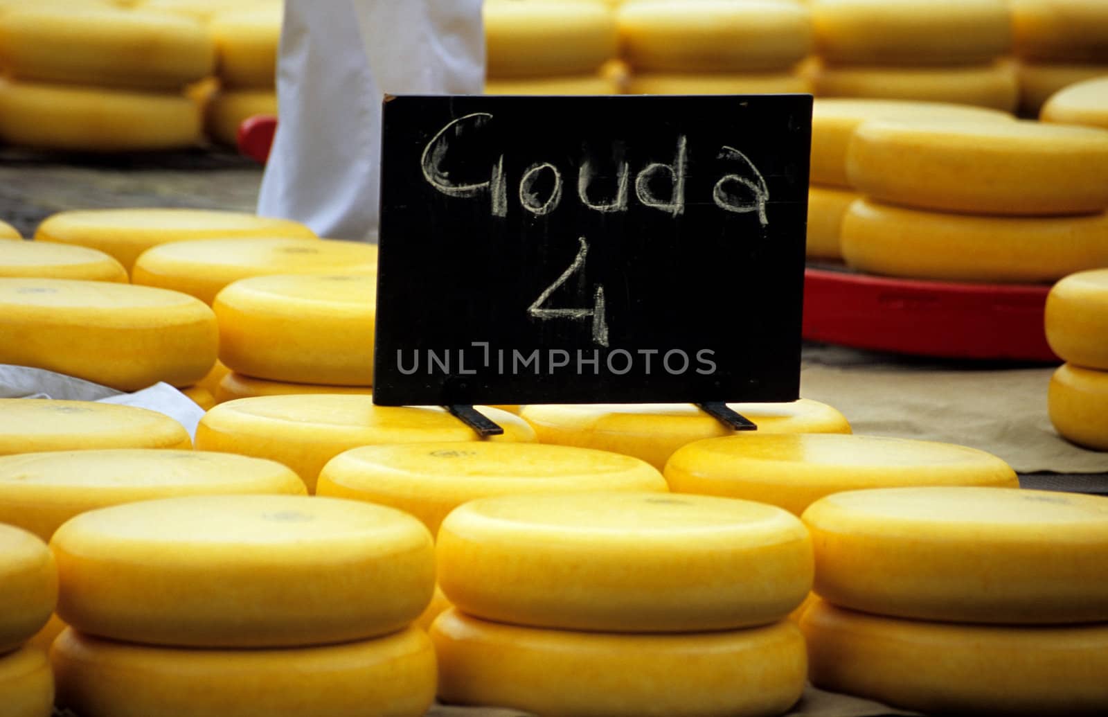 Stacks of Gouda cheese wheels wrapped in wax at the Alkmaar cheese market.