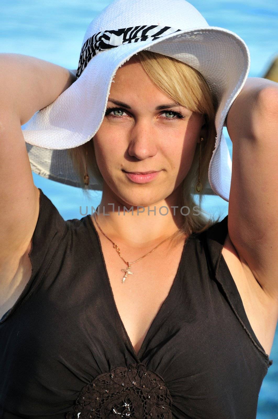 nice young lady in white hat  over blue sea