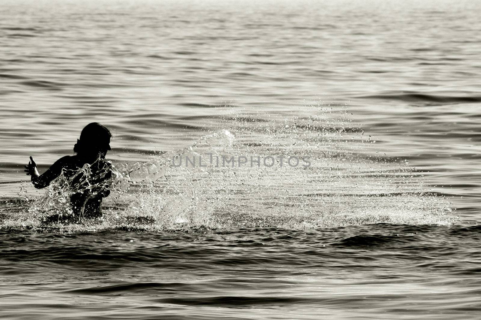 woman splashing water, sepia toned