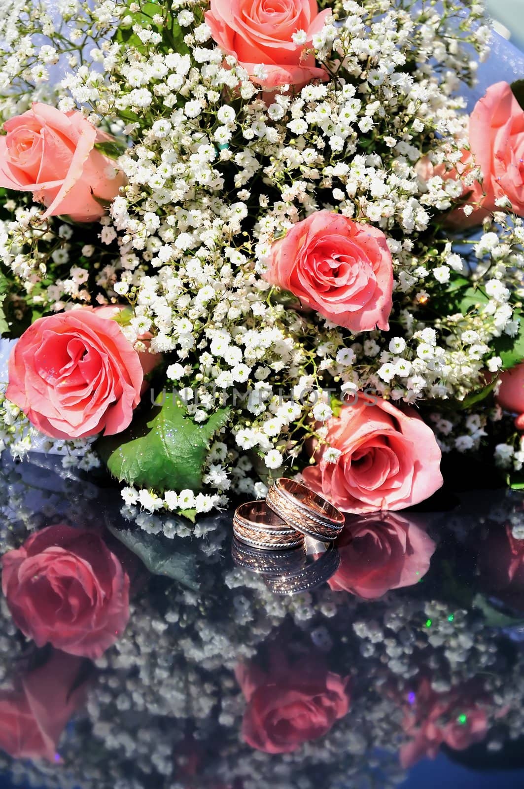 wedding pink flowers (roses) and gold rings 