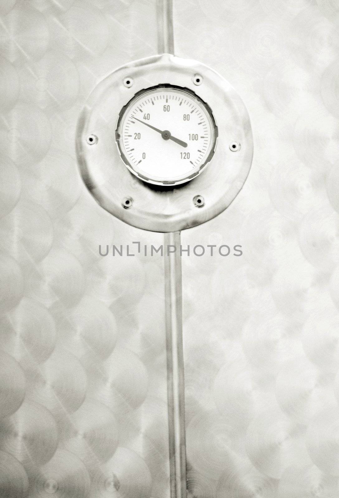 industrial temperature meter for liquids, selective focus on round thermometer, film grain added