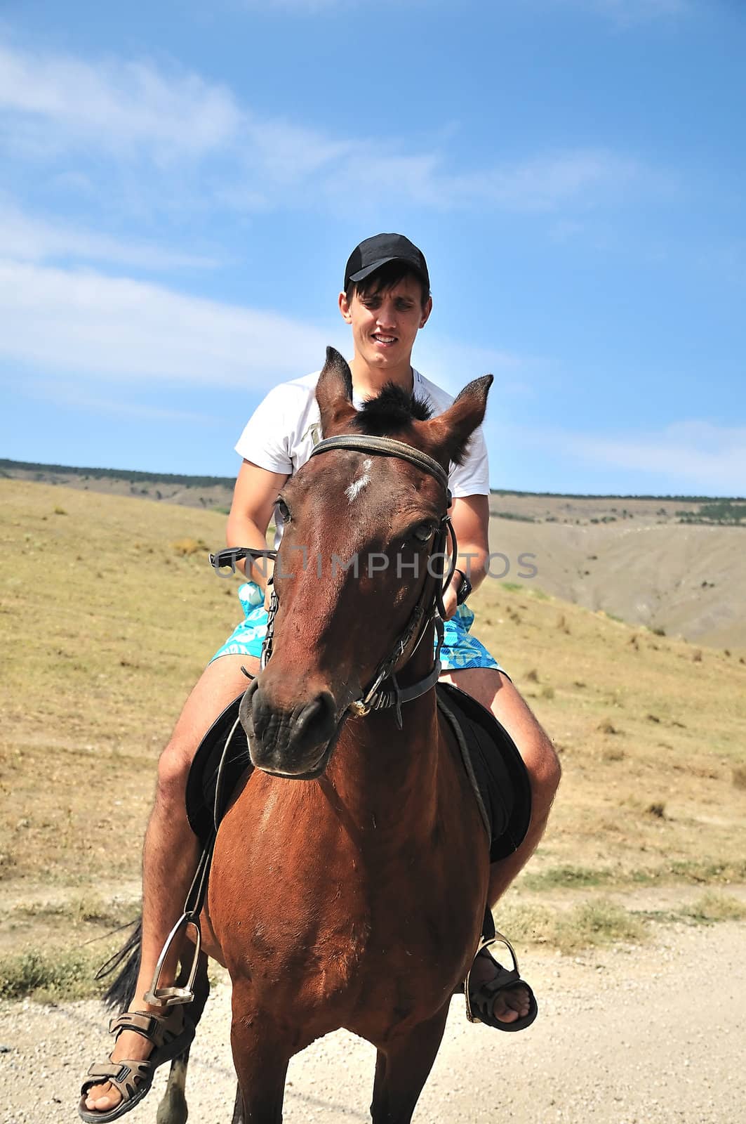 Man riding a horse, focus is on the horse's face 