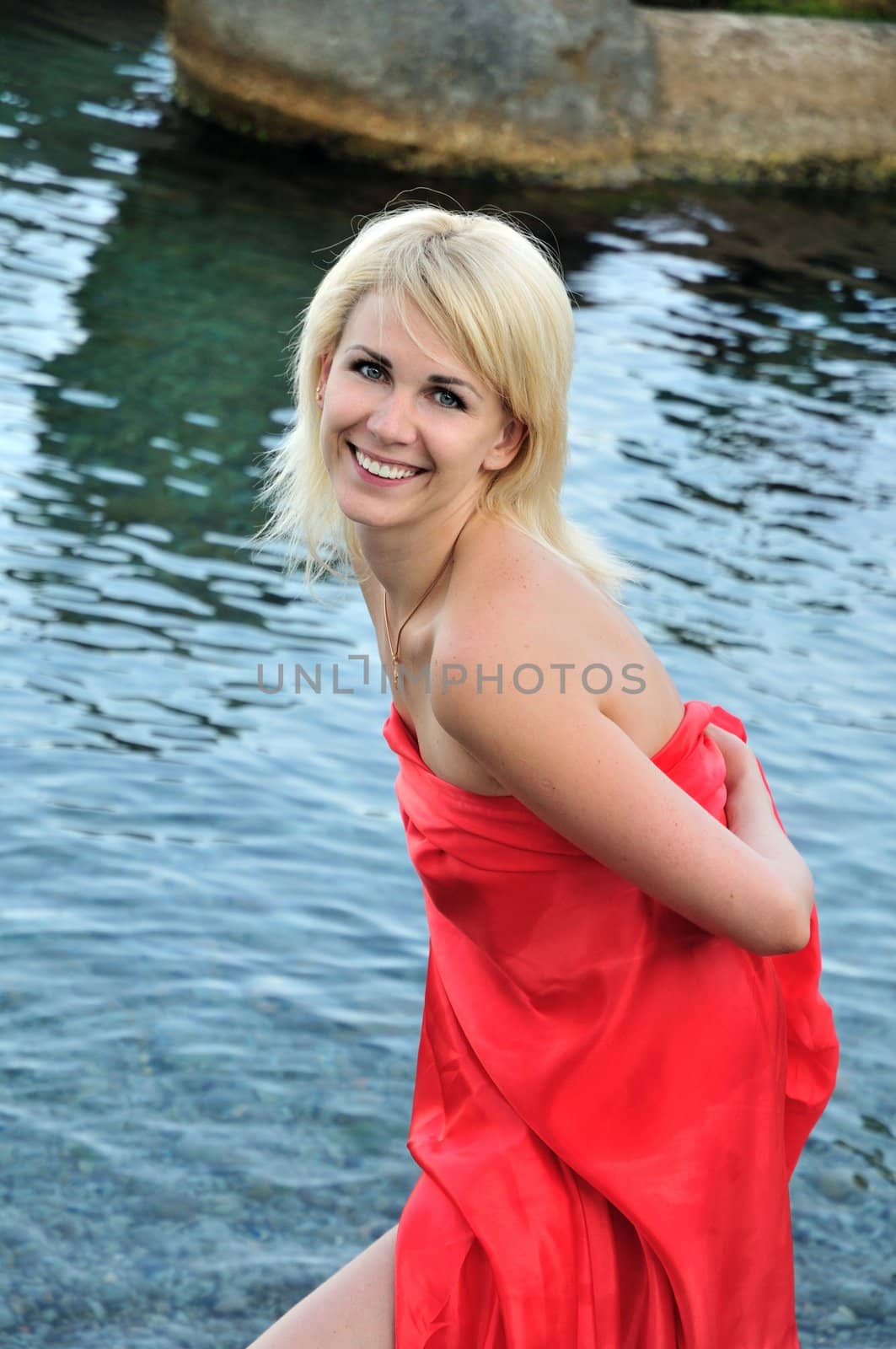 blond girl is laughing after bathing in sea
