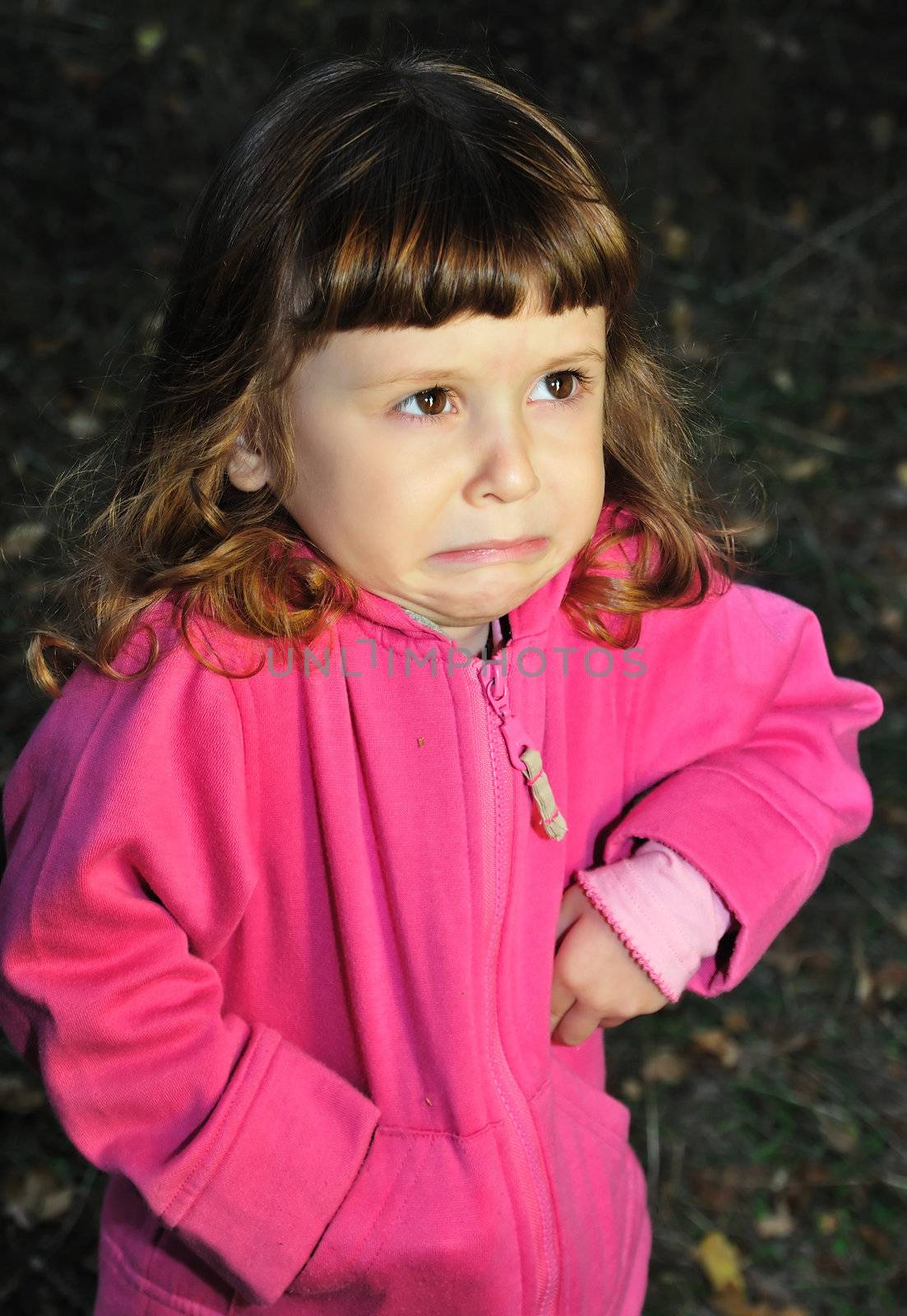  little girl with capricious expression on her face.
