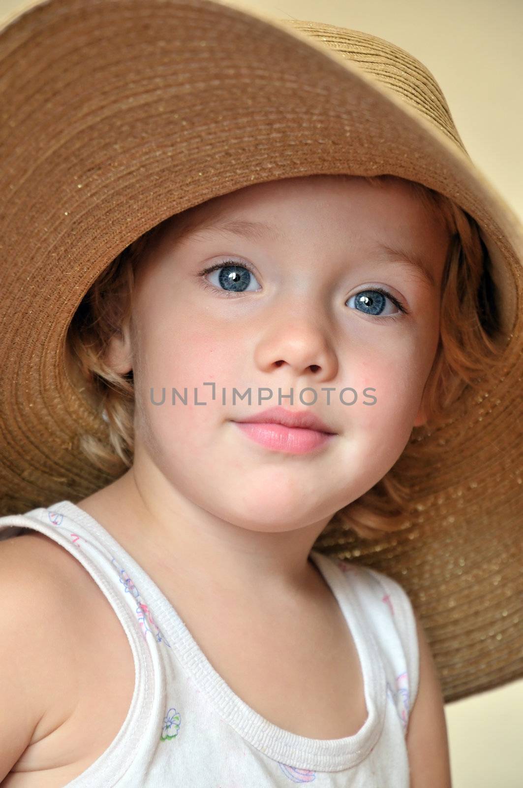 funny girl wearing huge straw  hat