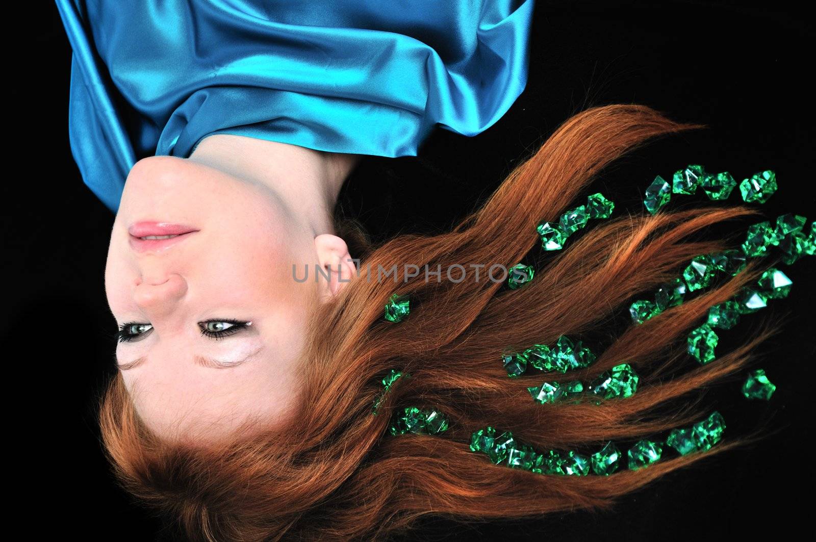 head of girl with natural red hair over black
