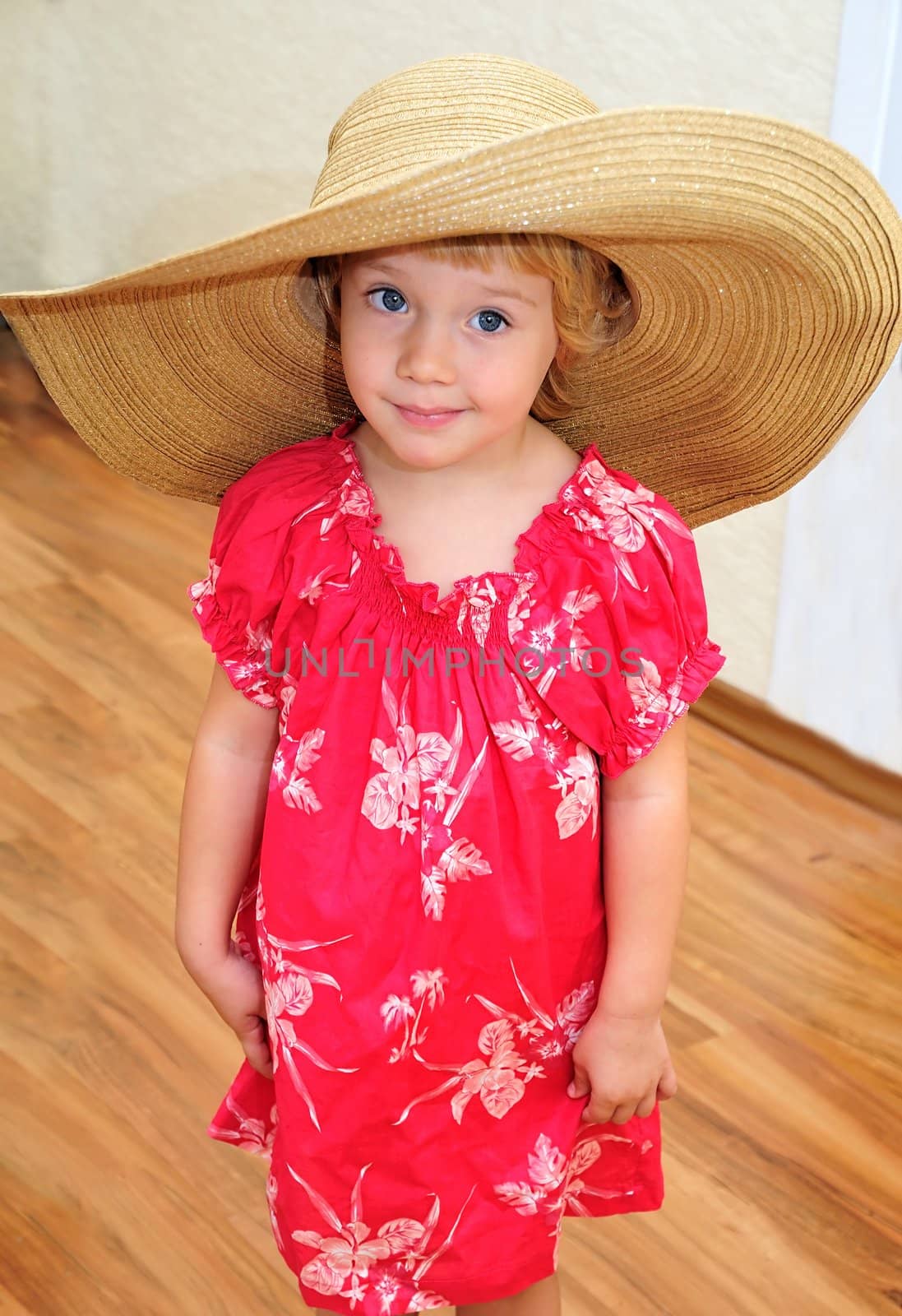  funny girl is wearing huge straw hat