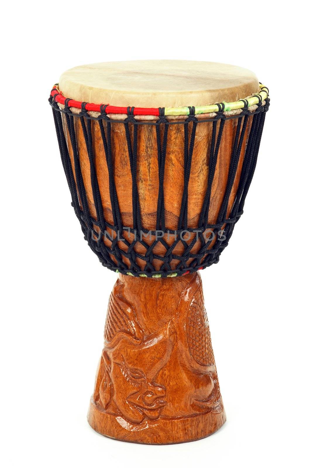Carved African djembe drum on white background.