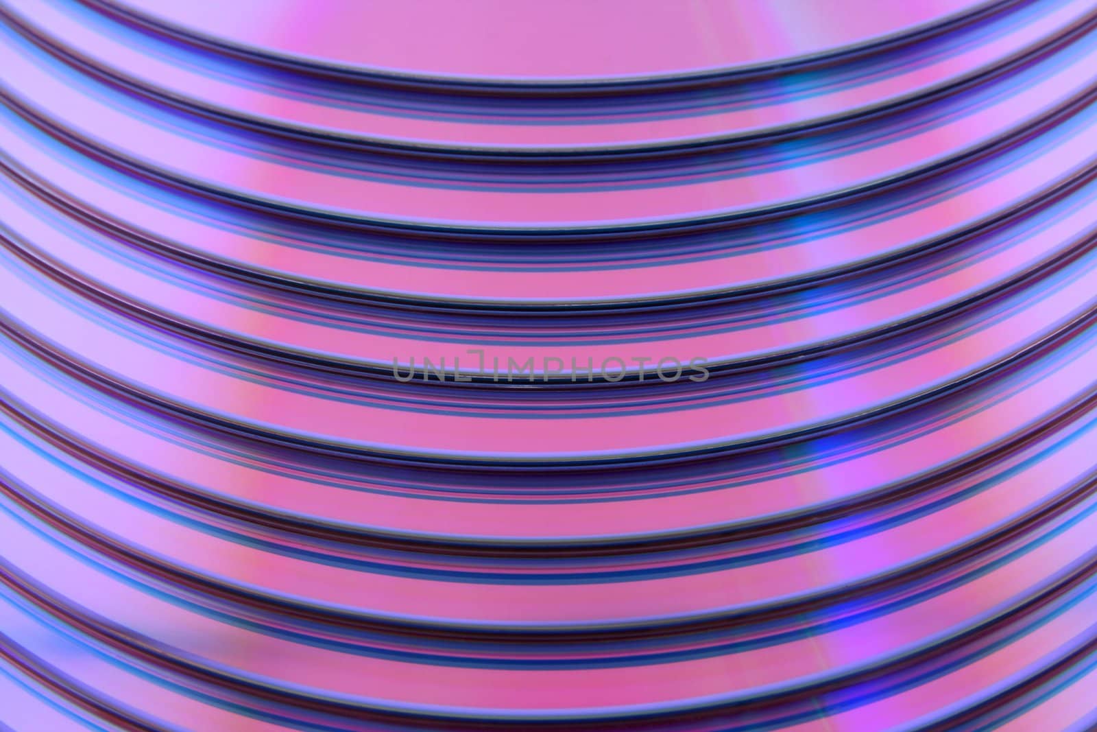 Abstract purple technology background. Closeup of stacked CDs.