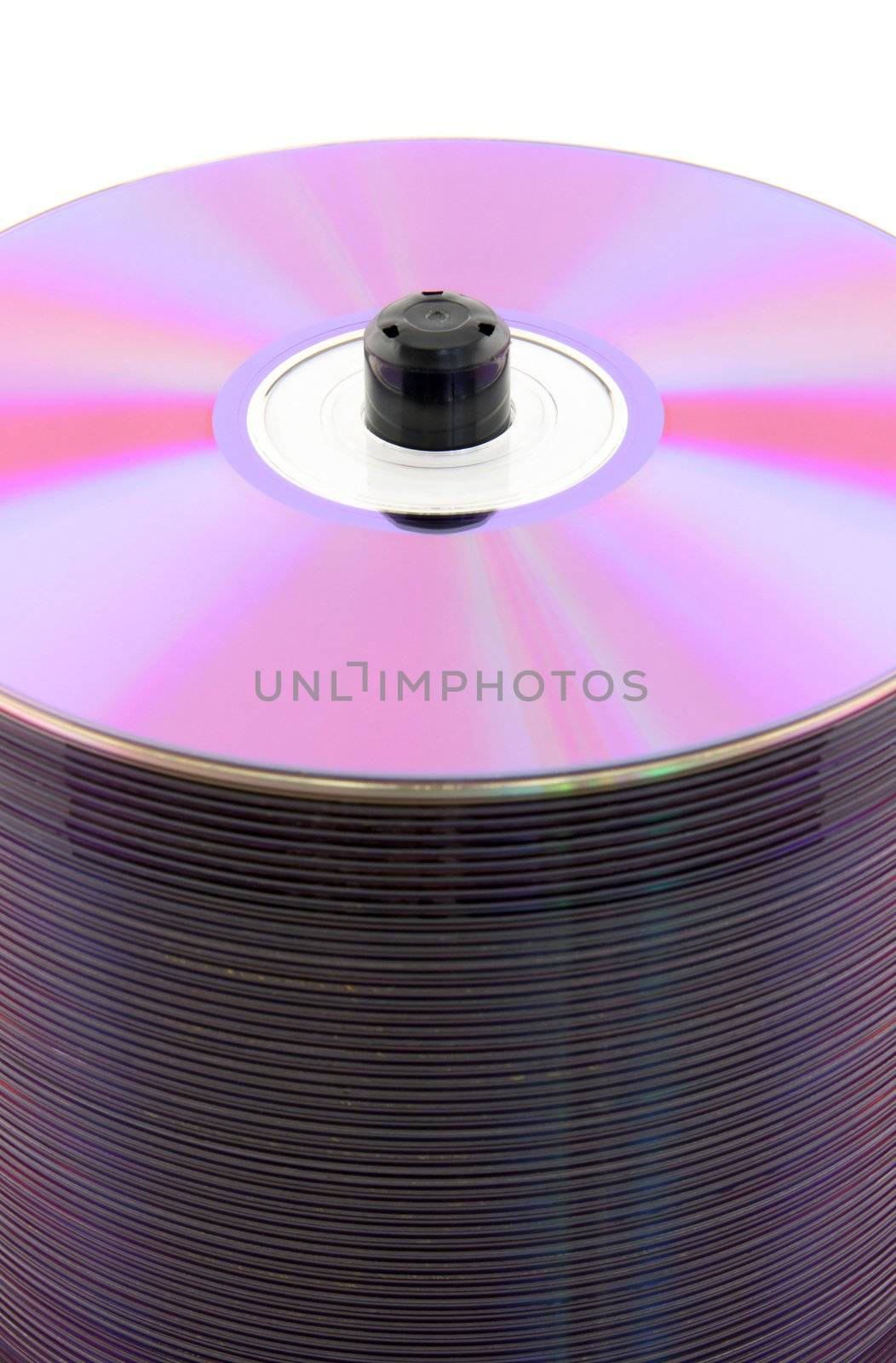 Purple CDs or DVDs on spindle, on white background. No dust.